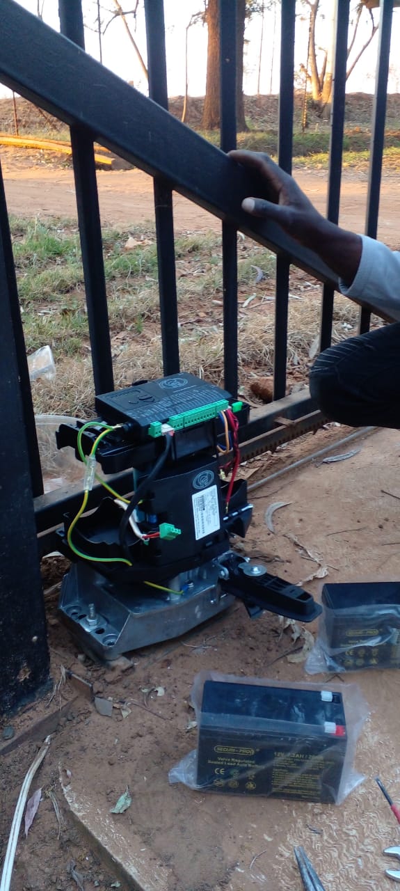 Mictech electrician installing a gate motor and wiring in Pretoria